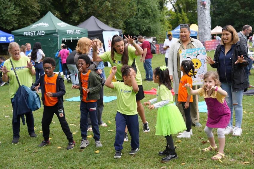 Children and helpers joining in a family activity in Shillington Park.