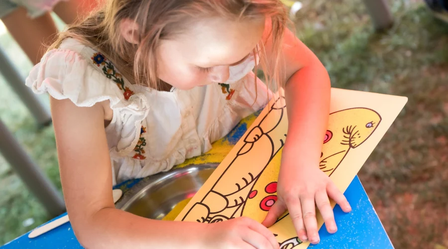 A girl colouring in a drawing