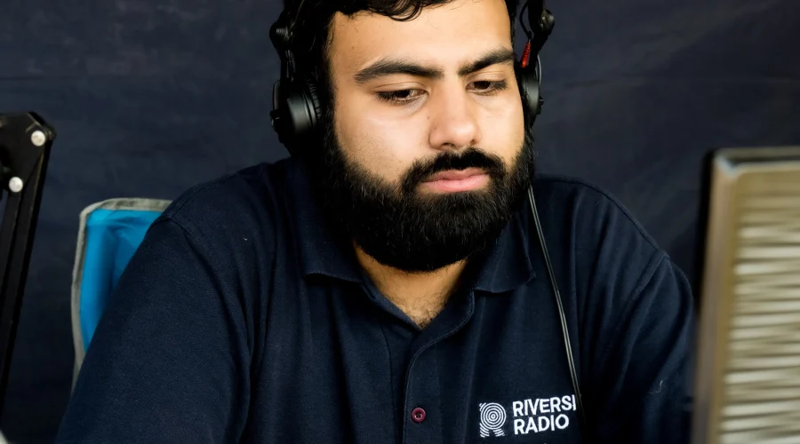 A Riverside Radio volunteer wearing a headset